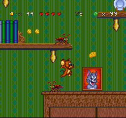Tom and Jerry (SNES) screenshot: Next place to explore: a room! This time, Jerry is about to catch a Cheese Chunk near Tom's photo...