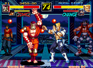 Kizuna Encounter: Super Tag Battle (Neo Geo) screenshot: Gozu strikes back Eagle with his Gokuenkai attack (the throwing of multiple hit-damaging fireballs).