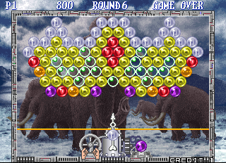 Bust-A-Move Again (Arcade) screenshot: The US version has no Puzzle Bobble characters, so the pointer is controlled by a pair of hands (Taito F3 system)