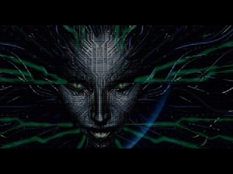 System Shock 2 (Windows) screenshot: Intro: a creepily familiar face appears right away...