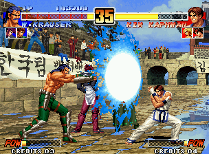 The King of Fighters '96 (Neo Geo) screenshot: Through his SDM Kaiser Wave, Wolfgang Krauser attempts to hit-strike back a defensive Kim Kaphwan.