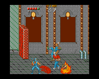 Ninja Gaiden (Amiga) screenshot: Barrels, crates, and other things can be destroyed if you throw an enemy on them. They contain bonus items, like this pill (restores health).