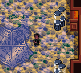 Harry Potter and the Sorcerer's Stone (Game Boy Color) screenshot: Harry in the Foyer of Hogwarts.