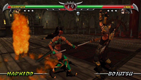 Mortal Kombat: Unchained (PSP) screenshot: Jade poking Scorpion.