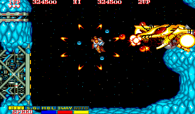 Side Arms Hyper Dyne (Arcade) screenshot: Level 3: Final nemesis.<br> This armoured mech-type vehicle has just received the last deadly bolt. It's about to get destroyed.