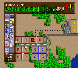 SimCity (SNES) screenshot: The beginnings of a city, the colored squares represent vacant lots.