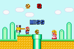 Mario Party-e (Game Boy Advance) screenshot: Mario's Mallet: ouch. Don't hit Luigi.