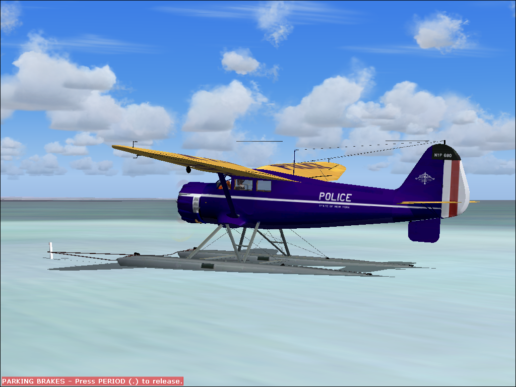 Roaring Thirties (Windows) screenshot: Stinson Gullwing, floats version, NYP livery, spot plane view. While the parking break is set, mooring wires to a pole is seen in the water.