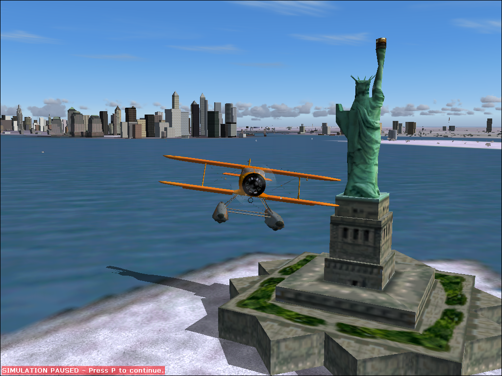 Roaring Thirties (Windows) screenshot: Beech Staggerwing, floats version, civilian livery (orange). Aircraft in flight in NY, buzzing the statue of liberty.