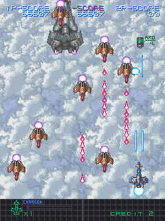 U.N. Defense Force: Earth Joker (Arcade) screenshot: A mini boss and some critters, note the torpedo (ARD) power-up