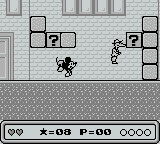 Mickey's Dangerous Chase (Game Boy) screenshot: Lobbing a block at a suspicious character.