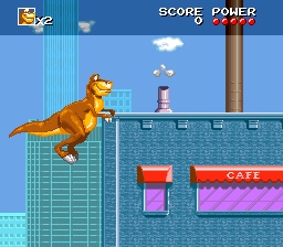 We're Back!: A Dinosaur's Story (SNES) screenshot: Trying to jump on top of a building.
