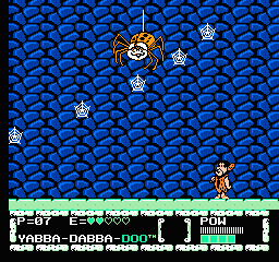 The Flintstones: The Surprise at Dinosaur Peak! (NES) screenshot: The big spider boss throwing small webs to Fred.