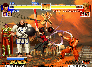 The King of Fighters '96 (Neo Geo) screenshot: Vice uses her move Ravenous (Outrage's air version) against Ryo Sakazaki: he's about to be struck...