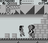 Kung' Fu Master (Game Boy) screenshot: The second boss is throwing barrels at you. Just go to the left side of the screen where he can't reach them.