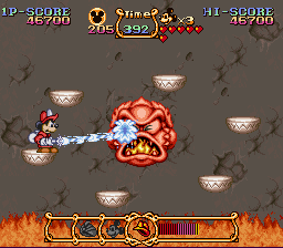 The Magical Quest Starring Mickey Mouse (SNES) screenshot: Boss fight - keep shooting at him before he heats up again.