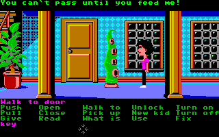 Maniac Mansion (Amiga) screenshot: Wendy runs into Green Tentacle. He won't let her pass until he gets some food.