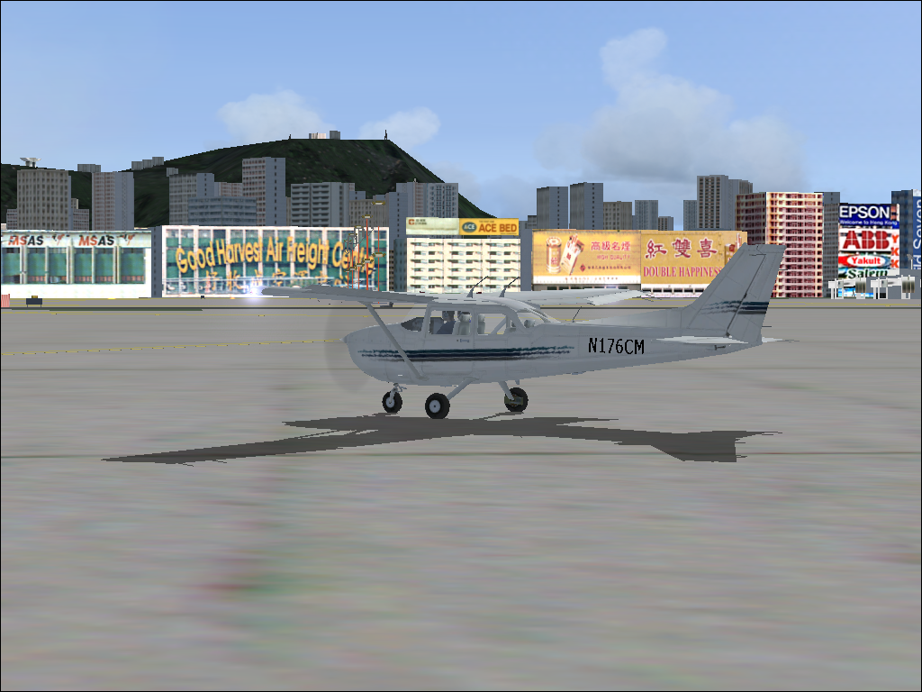 Hong Kong for Microsoft Flight Simulator 2004 (Windows) screenshot: Lots of advertising surrounding the airport; none of it was allowed to flash, so as not to be confused with the airport lights.