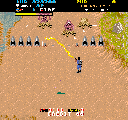 The Real Ghostbusters (Arcade) screenshot: Level 03:<br> Bases of trees hide dangerous foes.