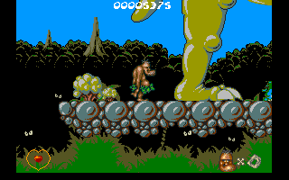 Chuck Rock (Amiga CD32) screenshot: Watch out, he's about to drop something!