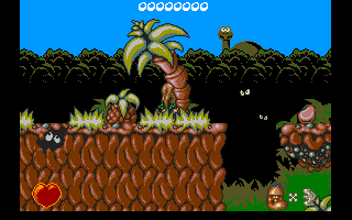Chuck Rock (Amiga CD32) screenshot: Chuck Rock, hiding behind a palm tree at the beginning of level 1.
