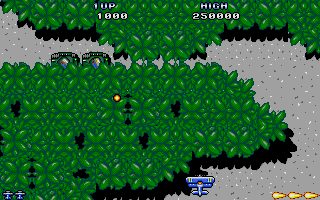Sky Shark (Atari ST) screenshot: Avoiding a shot from hiding tank.