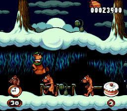 Adventures of Yogi Bear (Genesis) screenshot: To escape from the danger, Yogi jumps above a row of weasels... and he's about to stomp one of them!
