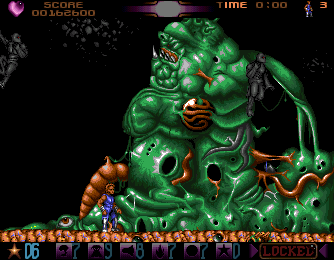 Assassin (Amiga) screenshot: The boss is not really the big green monster, but the jumping ninja-mutants (in lack of a better word) coming out of it.