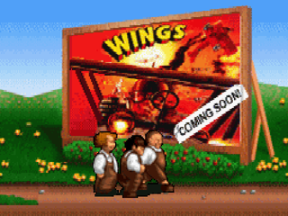 The Three Stooges (PlayStation) screenshot: <moby game="Wings">Wings</moby> billboard