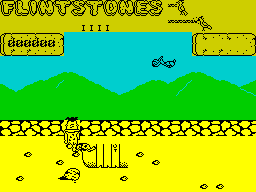 Yabba Dabba Doo! (ZX Spectrum) screenshot: Part of a house already exists to be extended into a full dwelling. Birds will drop rocks on Fred, turtles and other animals will attack him