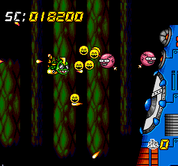 Super Air Zonk: Rockabilly-Paradise (TurboGrafx CD) screenshot: Boss battle against a wall that spits out smiling faces