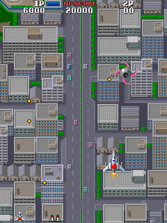 Asuka & Asuka (Arcade) screenshot: Flying over the city.