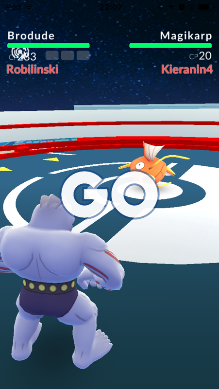 Pokémon GO (iPhone) screenshot: A typical gym battle.