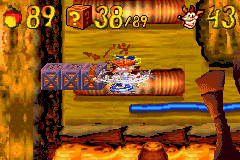 Crash Bandicoot 2: N-Tranced (Game Boy Advance) screenshot: Crash (once again equipped with his helicopter-based gadget) breaking some floating crates.