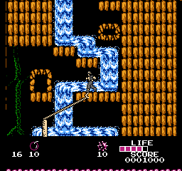 Arumana no Kiseki (NES) screenshot: Using the grappling hook to climb a waterfall.