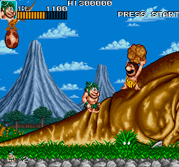 Joe & Mac: Caveman Ninja (Arcade) screenshot: He throws rock