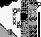 Trax (Game Boy) screenshot: A barricaded cave entrance.