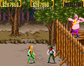 Sunset Riders (Arcade) screenshot: Boss behind barricade