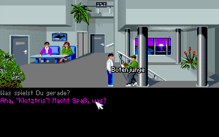 Das Telekommando kehrt zurück (Amiga) screenshot: You reach the fourth floor and talk to the errand boy, who is absorbed by his "Klotztris" game.