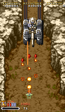 1941: Counter Attack (Arcade) screenshot: Some sort of bigger vehicle on rails, it seems.
