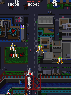 Asuka & Asuka (Arcade) screenshot: Zooming over the city.