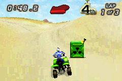 Quad Desert Fury (Game Boy Advance) screenshot: Those radioactive containers are actually nitro supplies.