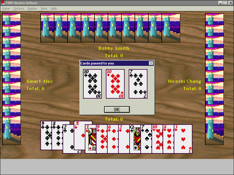 Hearts Deluxe (Windows) screenshot: After selecting cards to pass to their opponents the player naturally receives three cards