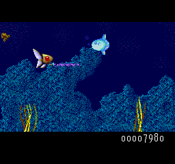 Deep Blue (TurboGrafx-16) screenshot: Shoot the green fish for power ups. Your health is indicated by the color of your submarine's eye.