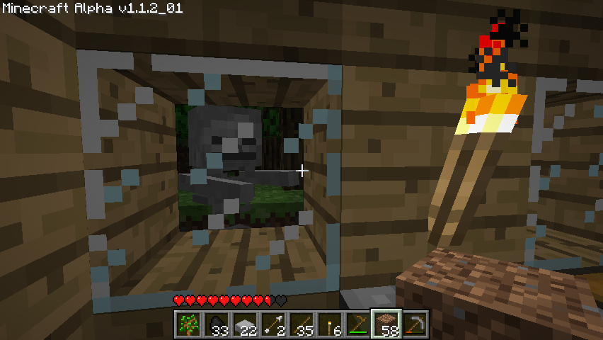 Minecraft (Windows) screenshot: My glass windows keeps the skeletons out.