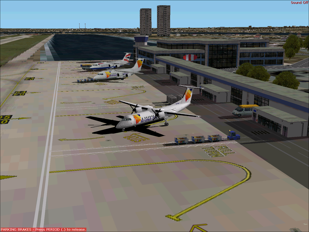 Dash 8-300 Professional (Windows) screenshot: The Dash 8-Q300 in British European livery on the ground at London City airport with the flight simulator's default scenery in the background