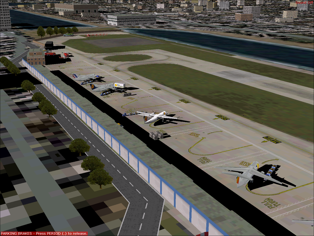 Dash 8-300 Professional (Windows) screenshot: The Dash 8-Q300 in British European livery on the ground at London City airport with the flight simulator's default scenery in the background