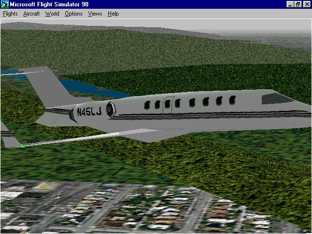 Microsoft Flight Simulator 98 (Windows) screenshot: The Learjet 45 in flight with landing gear retracted