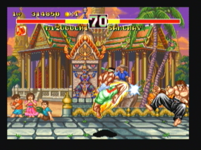 Fighter's History Dynamite (Zeebo) screenshot: Samchay hits Misogushi with a Ti Kau Koon.