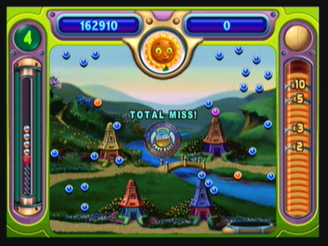 Peggle (Zeebo) screenshot: If your shot misses all pegs, a coin will be flipped. You can either lose that ball or get a free one.